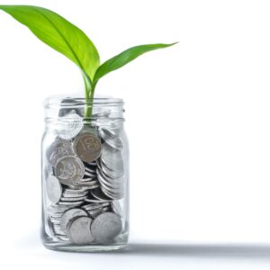 A jar full of coins and a plant growing out of it.