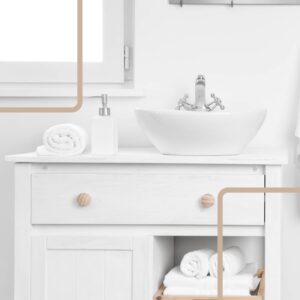 A white bathroom cabinet with a white sink and rolled white towels